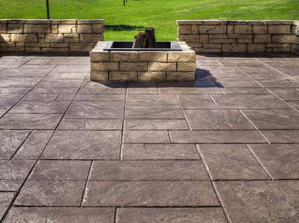 Custom stamped-concrete patio with stone fountain in Houston, TX